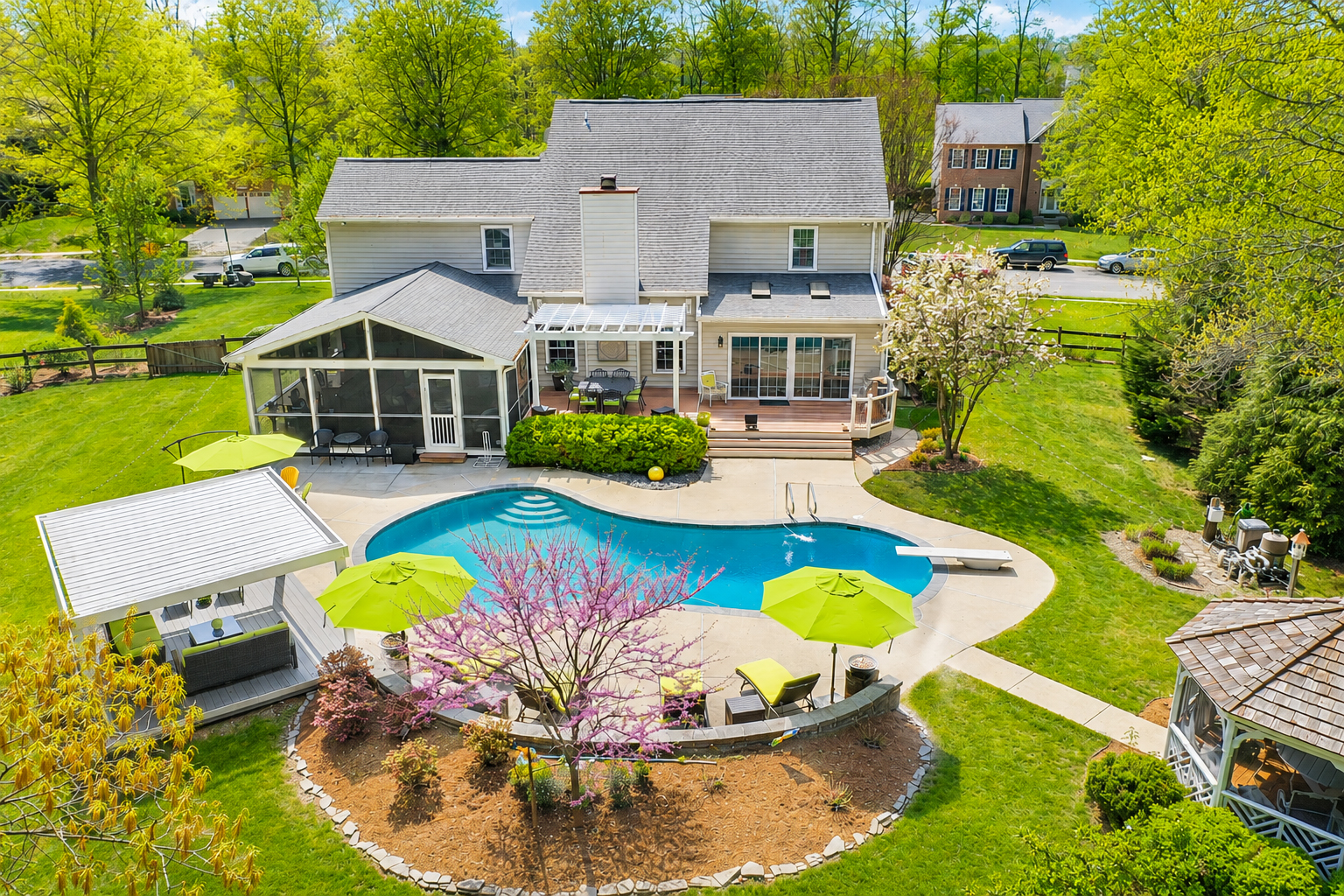 Professional aerial real estate photography of a home and backyard pool